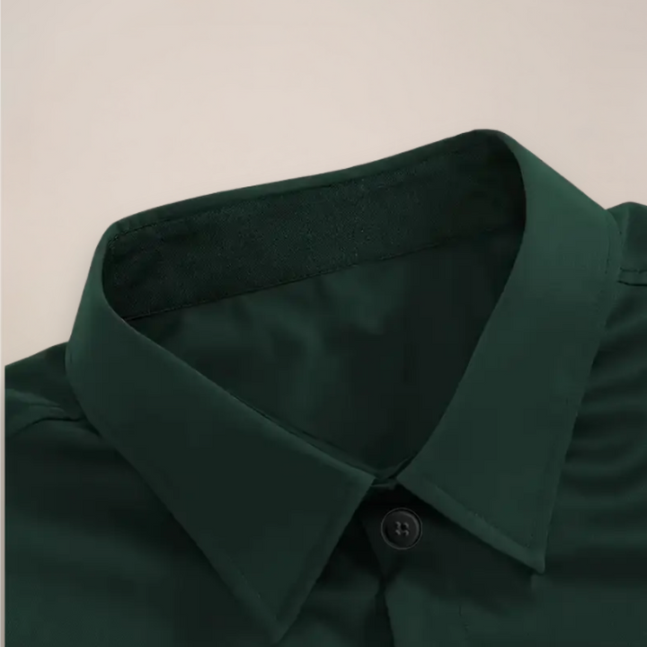 Close-up of dark green shirt collar with black contrast lining and button