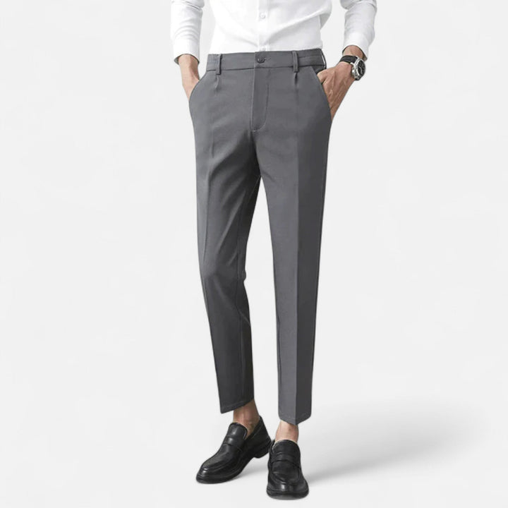 Grey slim-fit ankle-length trousers worn with white shirt and black loafers