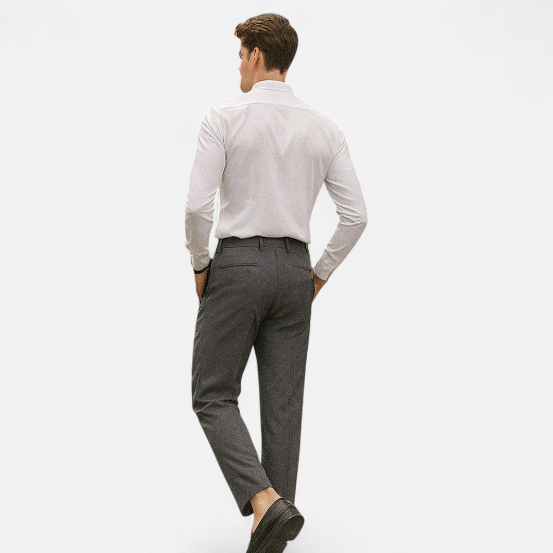 Charcoal tapered trousers with back pocket detail, styled with a white shirt