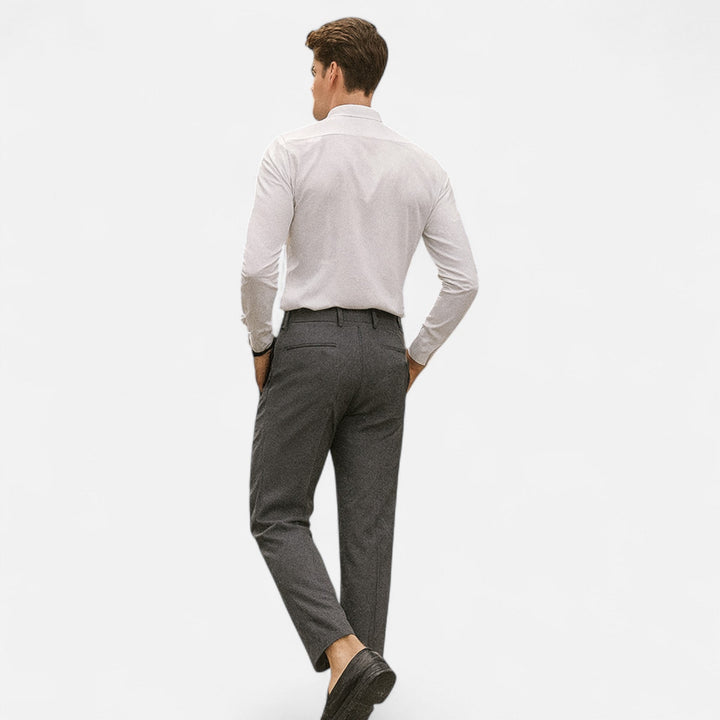 Charcoal tapered trousers with back pocket detail, styled with a white shirt