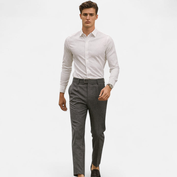 Grey tailored ankle-length trousers paired with white shirt and black loafers