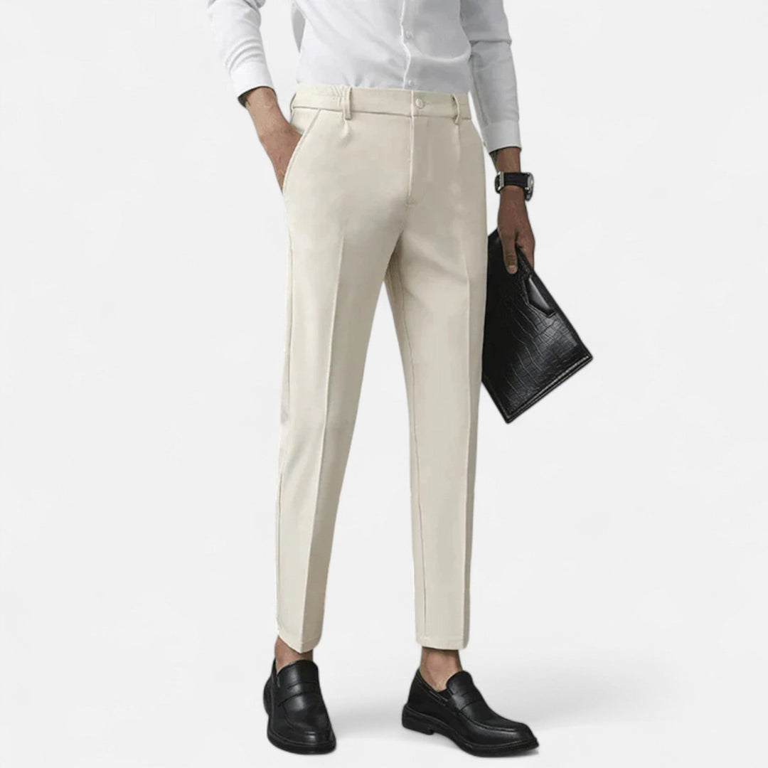 Cream slim-fit ankle-length trousers styled with white shirt and black loafers