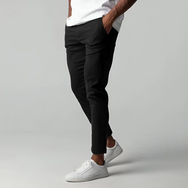 Black slim-fit chinos worn with white trainers, tapered ankle length