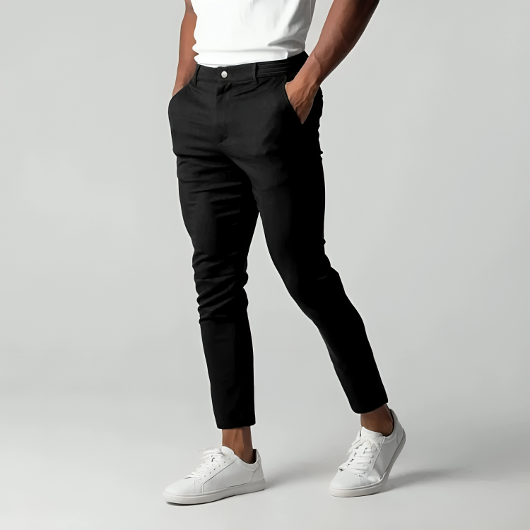 Front view of black tapered trousers with button and zip fastening