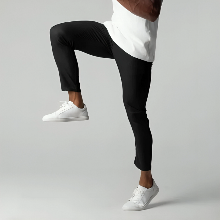 Man striding in black skinny-fit chinos paired with white trainers