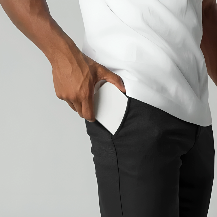 Close-up of black chino trouser pocket with elasticated waistband detail