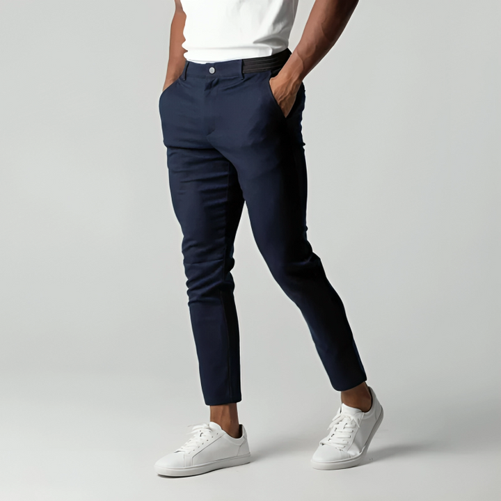 Navy slim-fit chinos styled with white trainers, tapered leg cut