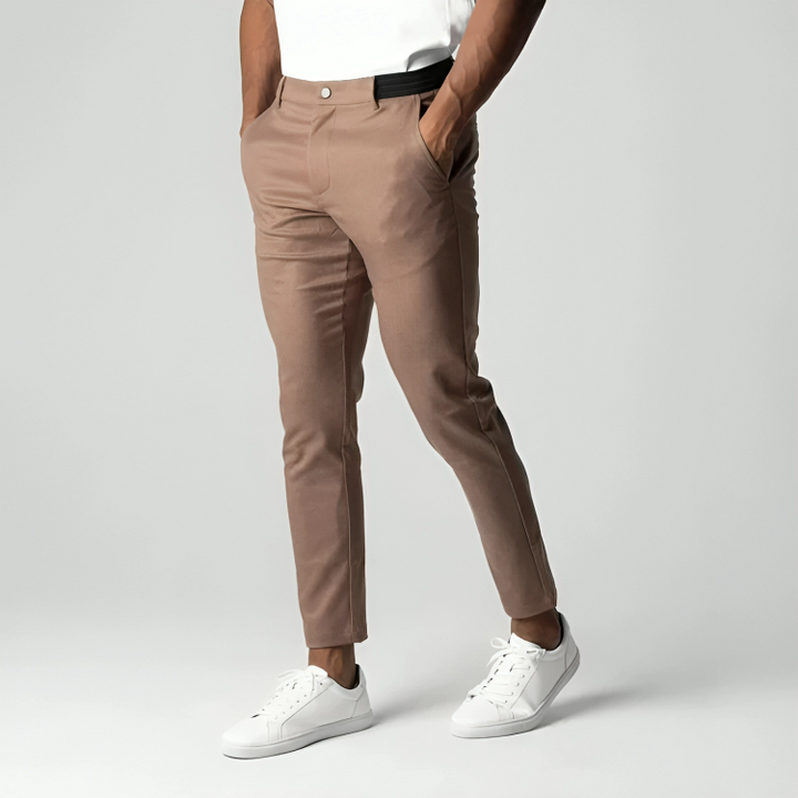 Camel-coloured slim chinos with elasticated waistband and white trainers