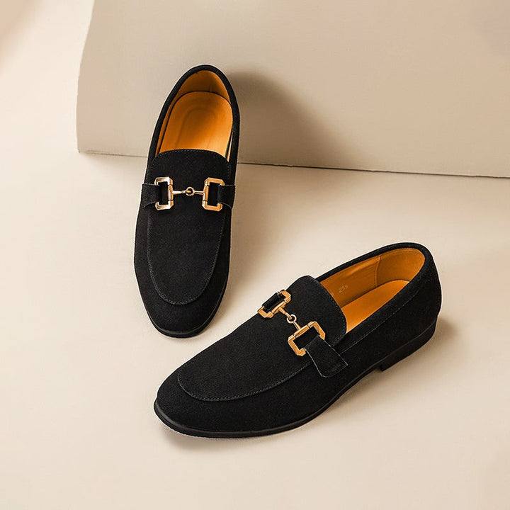 Black suede loafers with gold horsebit detailing, displayed side by side