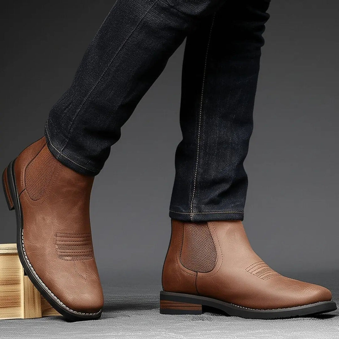 Model wearing brown Chelsea boots with dark jeans, western stitch detail