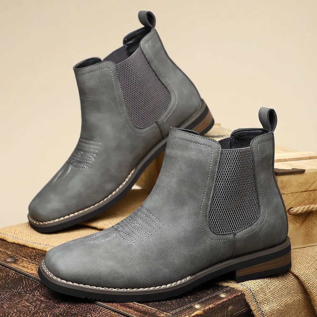 Pair of grey Chelsea ankle boots with ribbed elastic side inserts