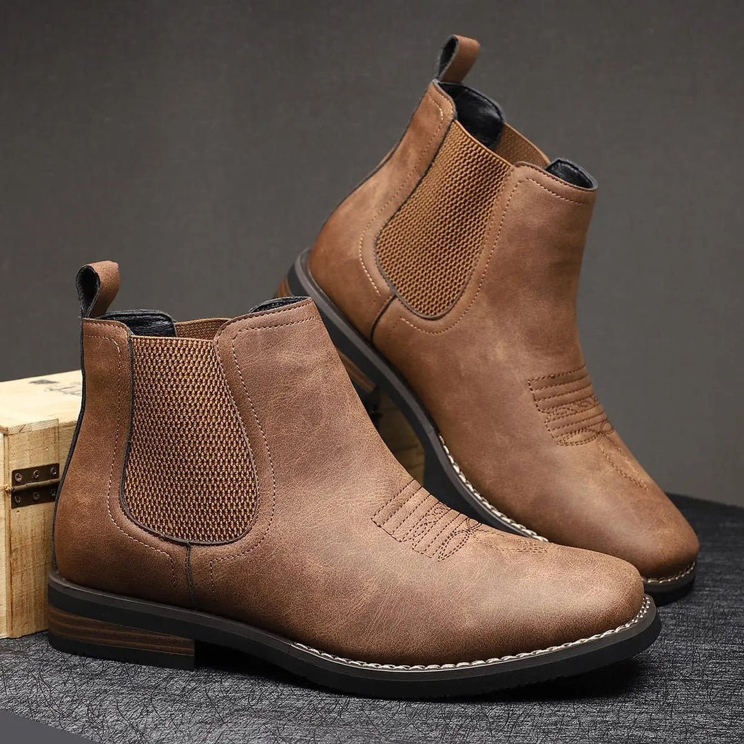 Brown leather Chelsea boots displayed together with stitched toe detail