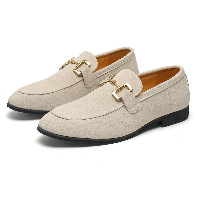 Cream suede loafers with gold hardware detail, displayed in a classic pair