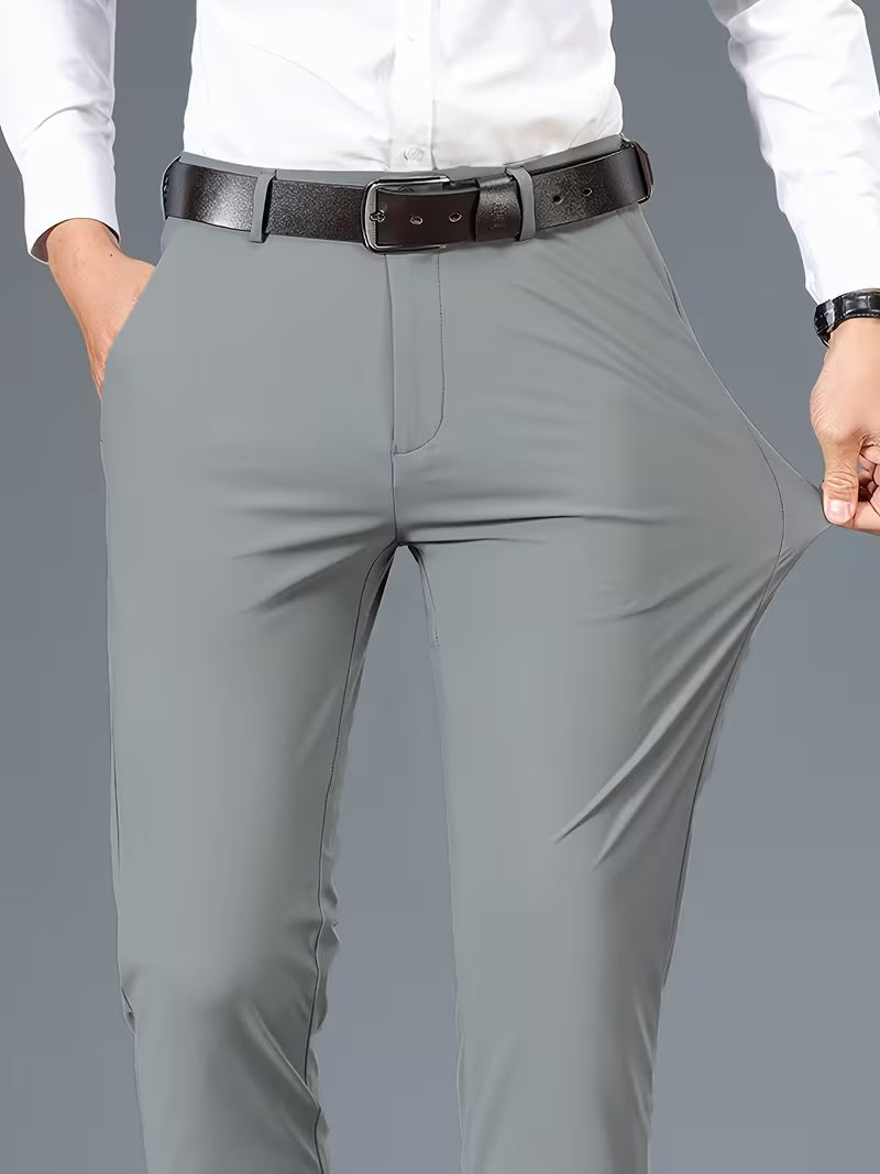 Grey stretch trousers close-up showing flexible fabric stretched at the thigh