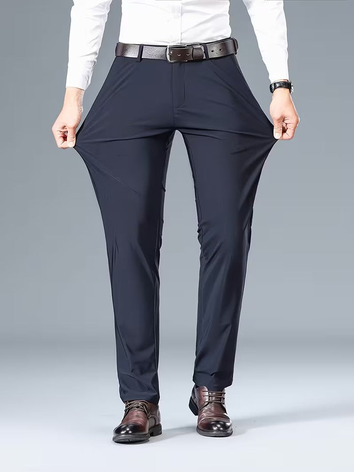 Navy stretch trousers stretched wide by hand to demonstrate flexible fabric