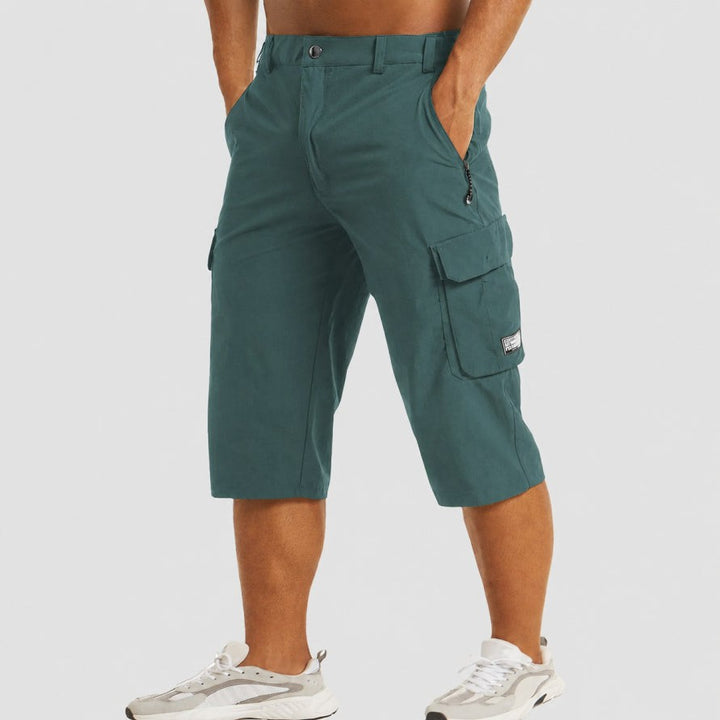 Teal green cropped cargo shorts showing side profile and flap pocket