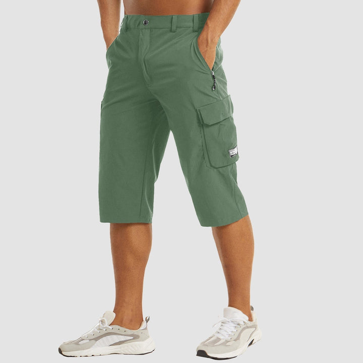Sage green three-quarter cargo shorts with flap pocket and zip fastening
