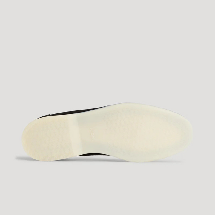 Underside view of loafer showing textured cream rubber sole