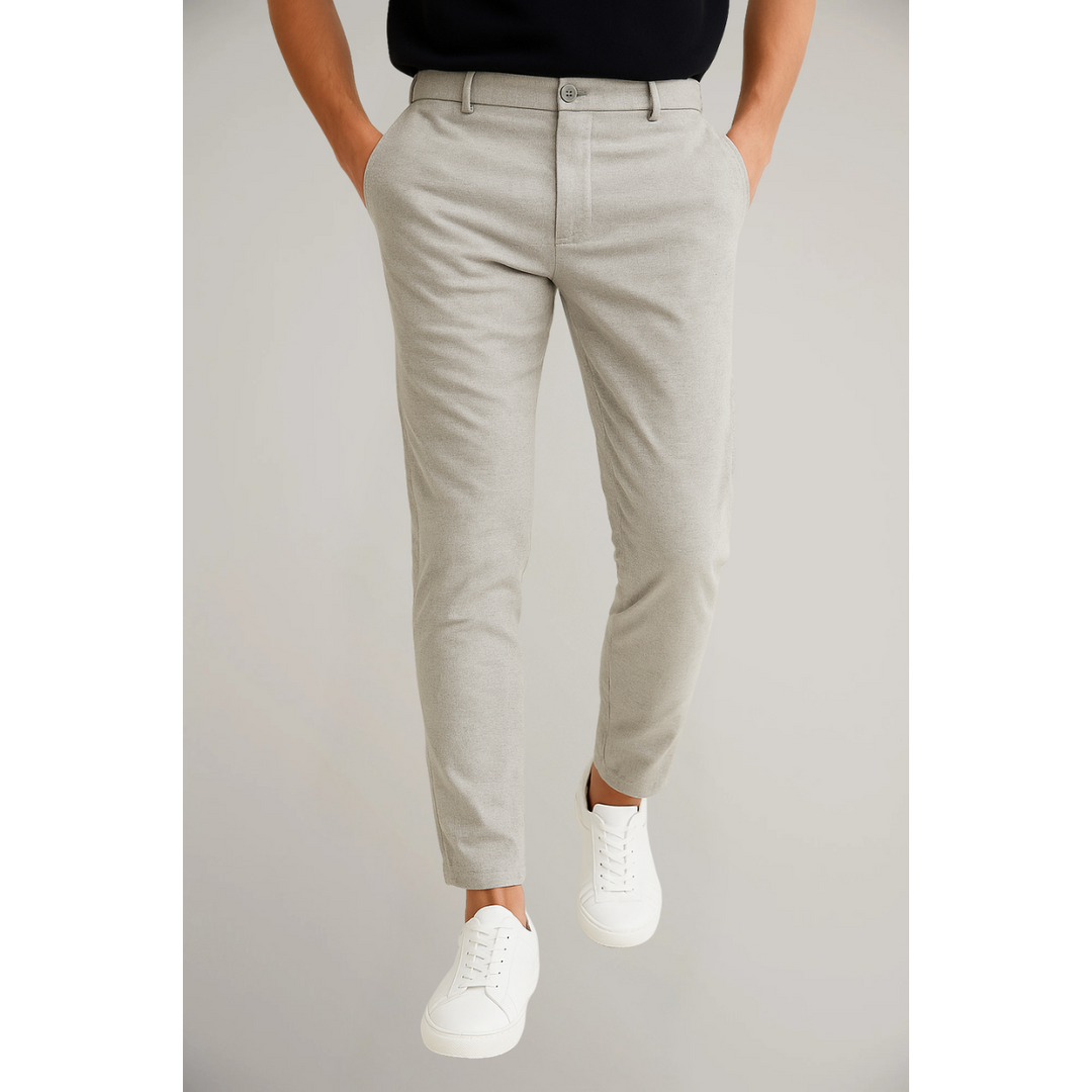 Light grey tailored slim leg trousers with tapered ankle and white trainers
