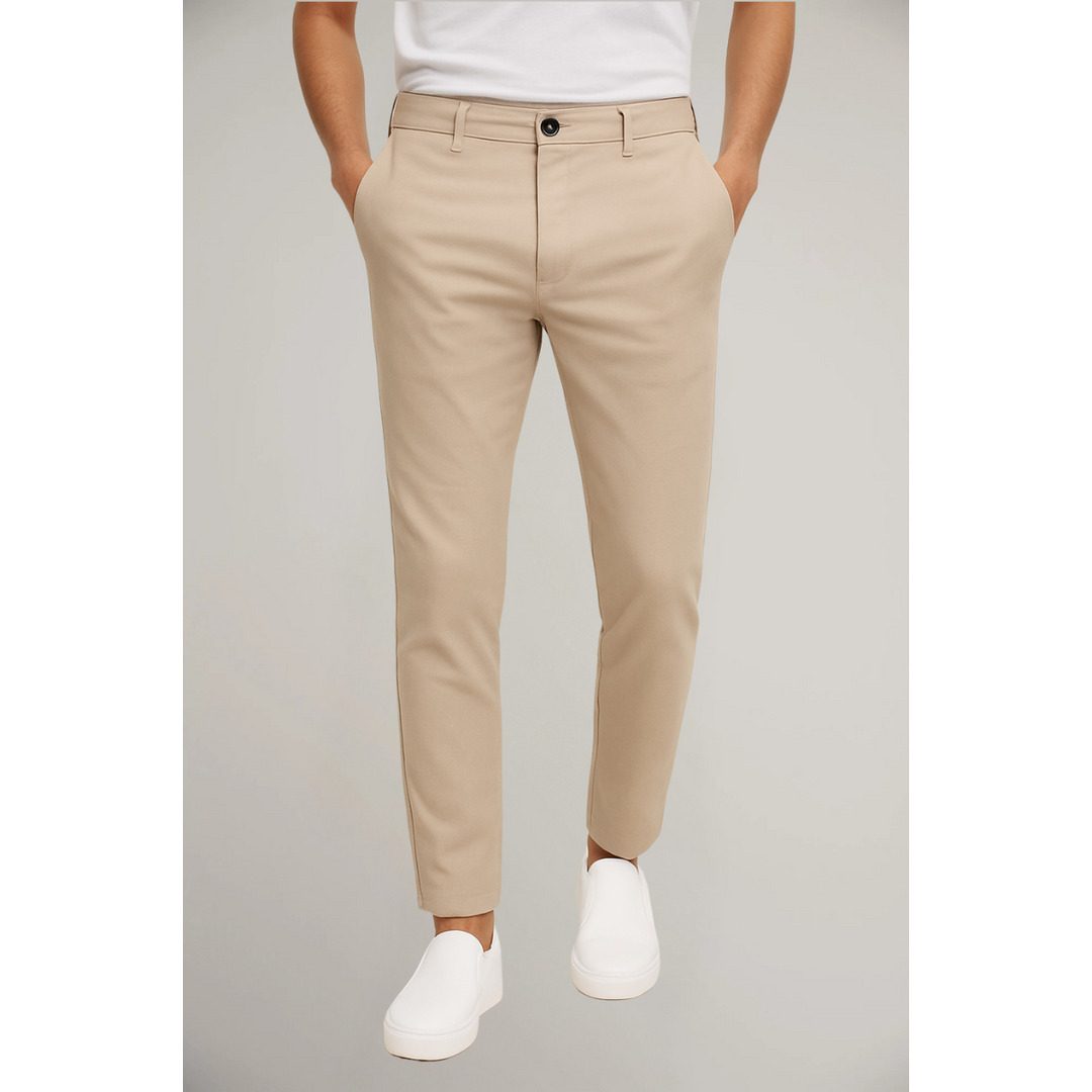 Beige tailored slim fit trousers paired with white t-shirt and slip-on shoes
