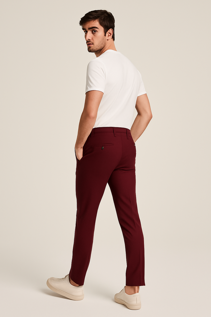 Rear view of burgundy slim fit tailored trousers with white sneakers