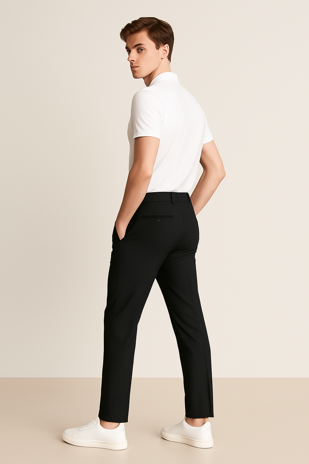 Black tailored trousers worn walking, rear view with white polo shirt
