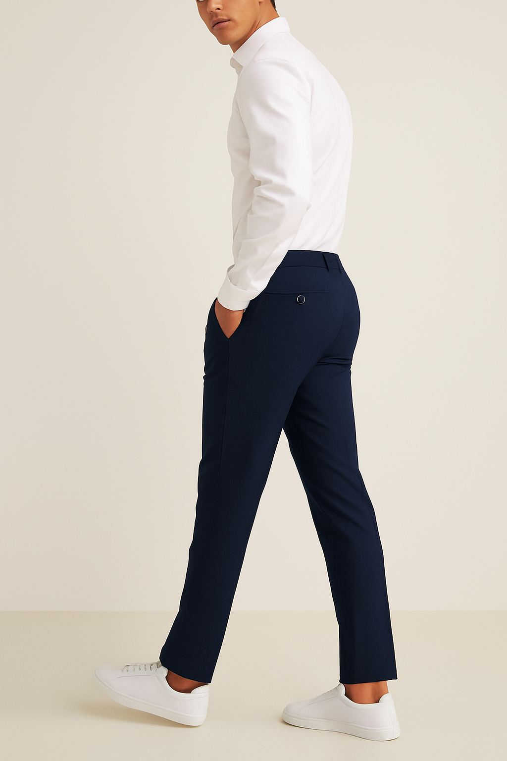 Navy slim fit tailored trousers shown from the side while walking
