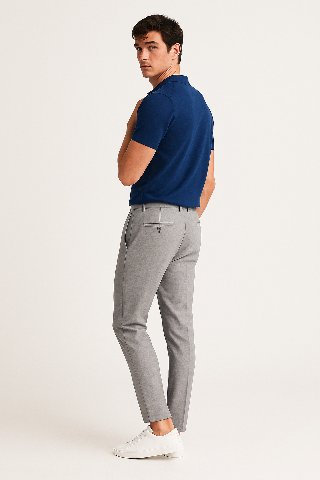 Grey marl tailored trousers worn with navy polo shirt, rear view