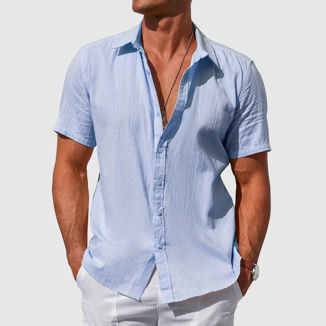 Men's sky blue textured linen shirt with short sleeves, worn open-collar