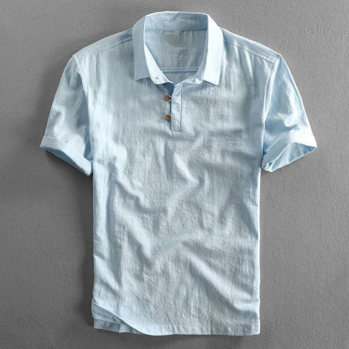 Pale blue linen polo shirt featuring classic collar and short sleeves