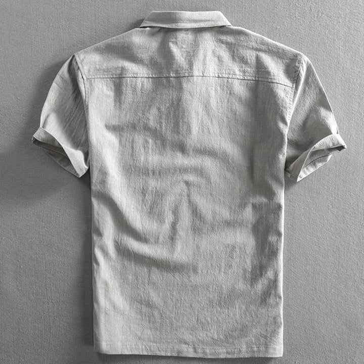 Rear view of grey linen polo shirt showing relaxed short sleeve fit