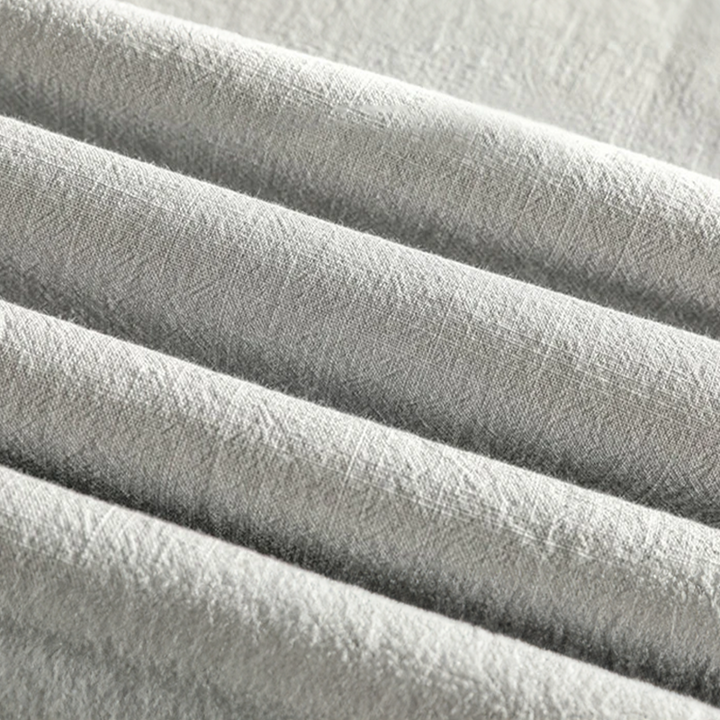 Textured grey linen fabric detail showing lightweight woven material