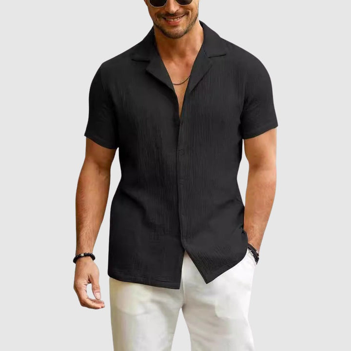 Black crinkled linen shirt featuring open camp collar and short sleeves