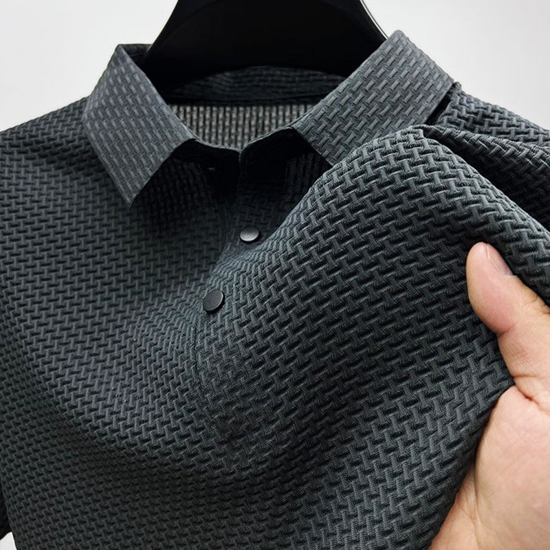Charcoal grey men's polo shirt with textured woven-effect fabric and popper buttons