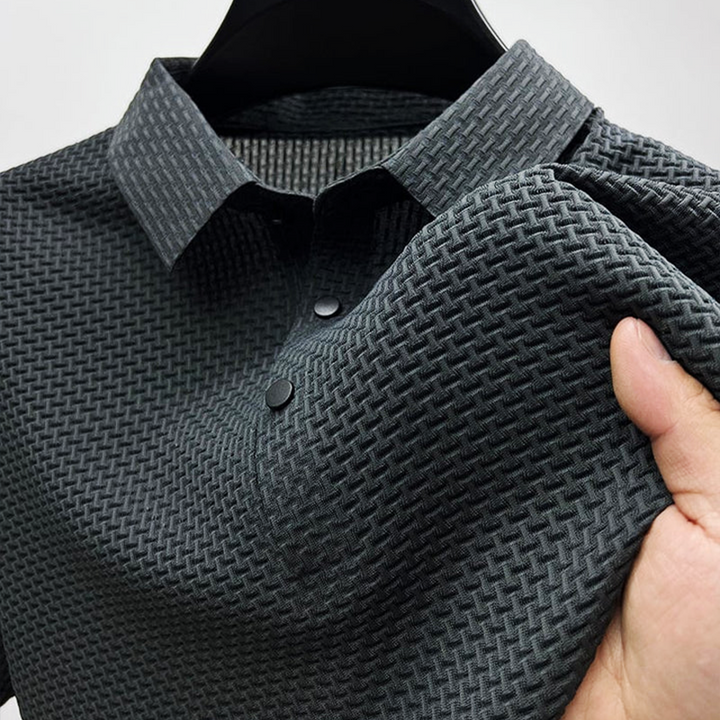 Charcoal grey men's polo shirt with textured woven-effect fabric and popper buttons