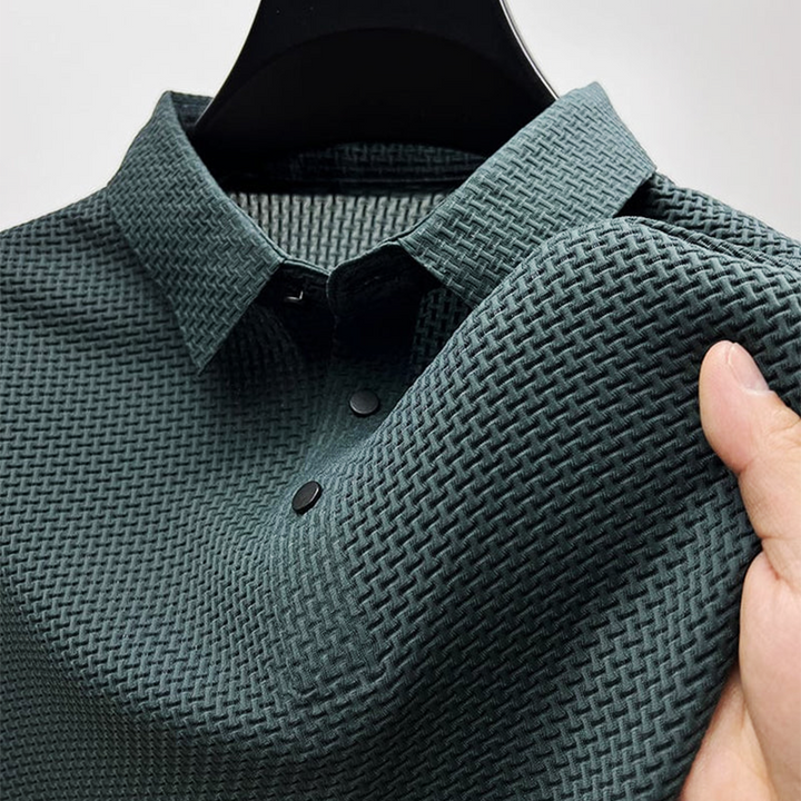 Dark green men's polo shirt showing textured knit collar and popper fastening