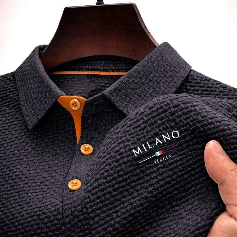 Black waffle-textured polo shirt with mustard buttons and chest embroidery