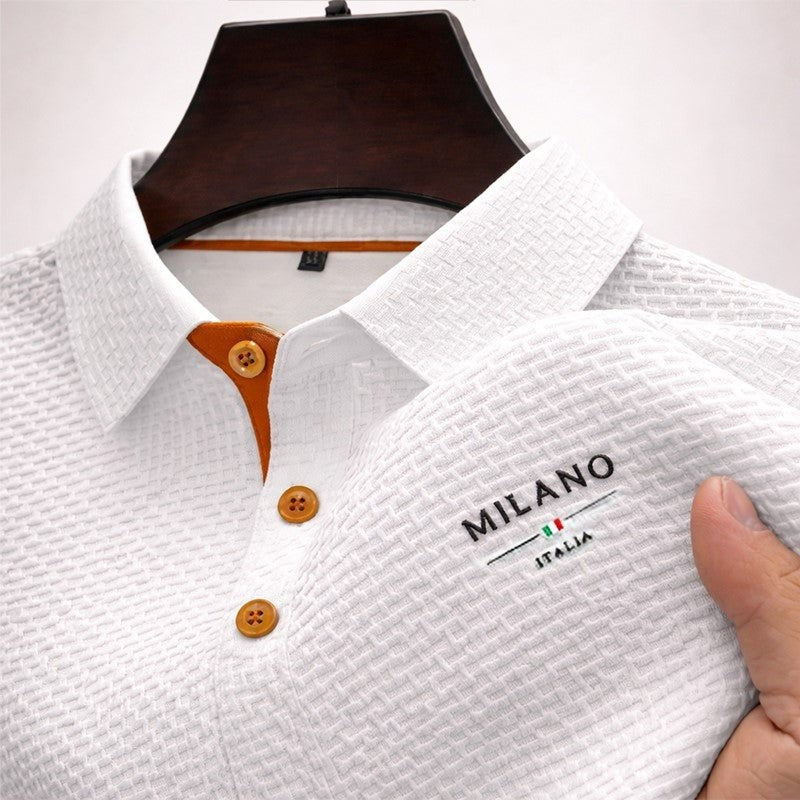 White textured polo shirt with contrast tan buttons and embroidered logo detail