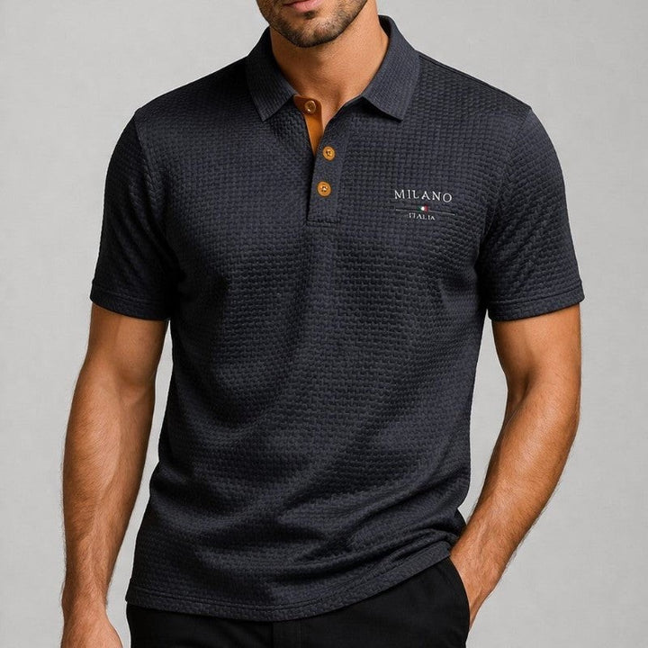 Man wearing charcoal textured polo shirt with tan buttons and short sleeves