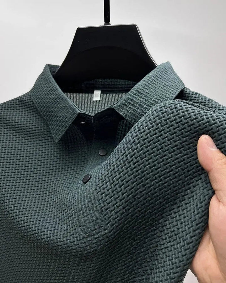 Dark green textured knit polo shirt on hanger with woven texture close-up