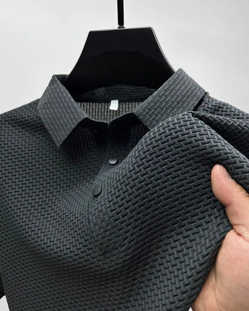 Charcoal textured knit polo shirt displayed on hanger showing fabric weave