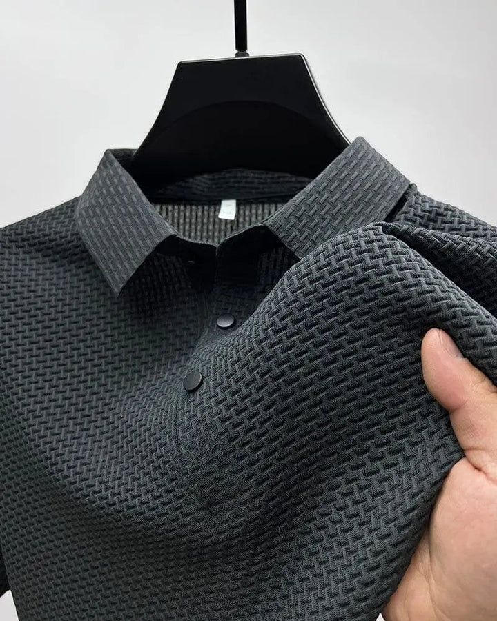 Charcoal textured knit polo shirt displayed on hanger showing fabric weave
