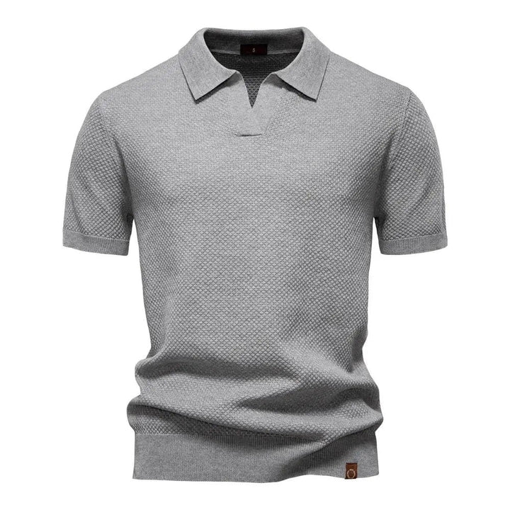 Grey textured knit polo shirt with buttonless V-neck and short sleeves