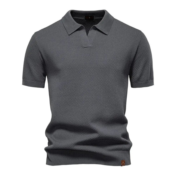 Charcoal grey knitted polo shirt with short sleeves and open collar