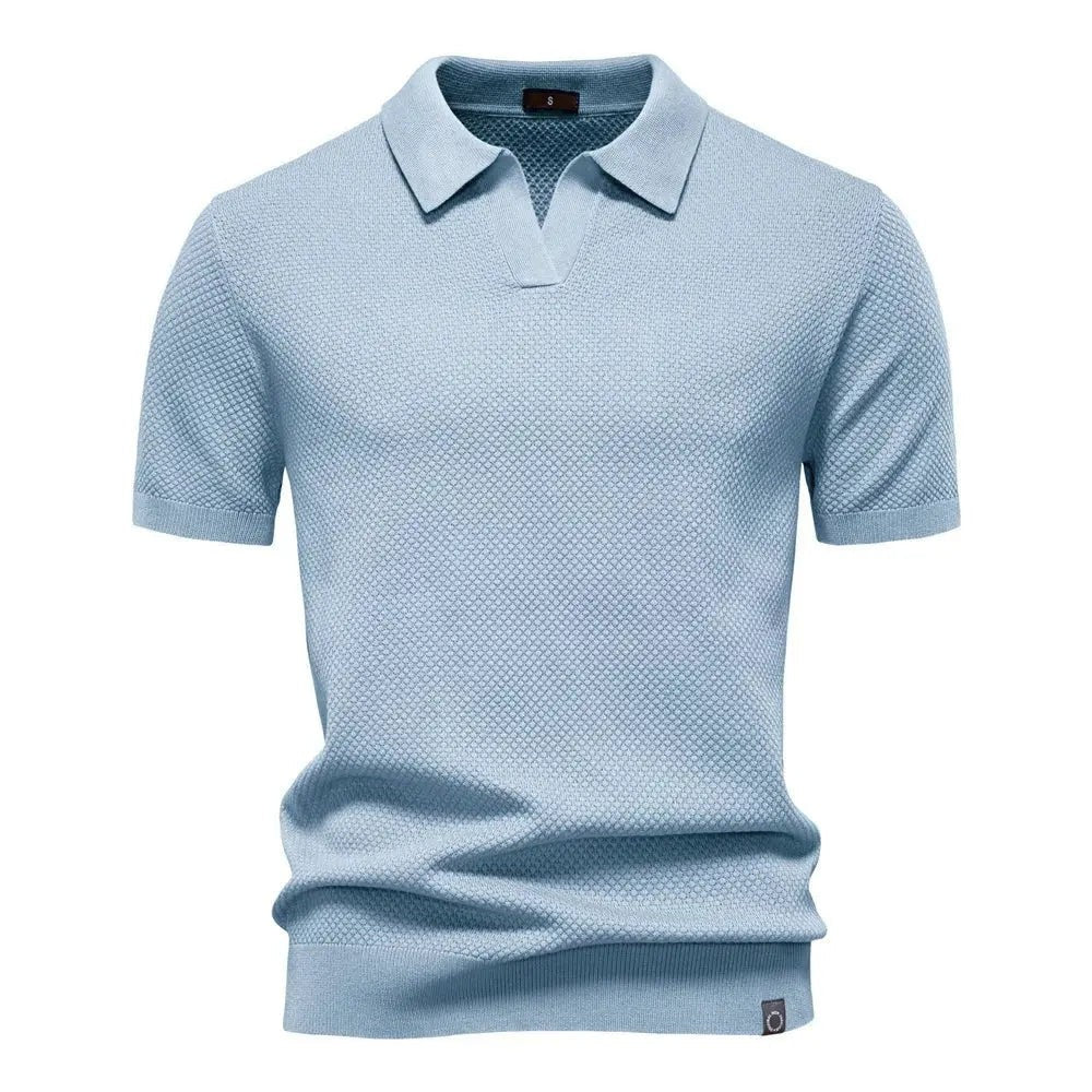 Pale blue knitted polo shirt with short sleeves and collared neckline