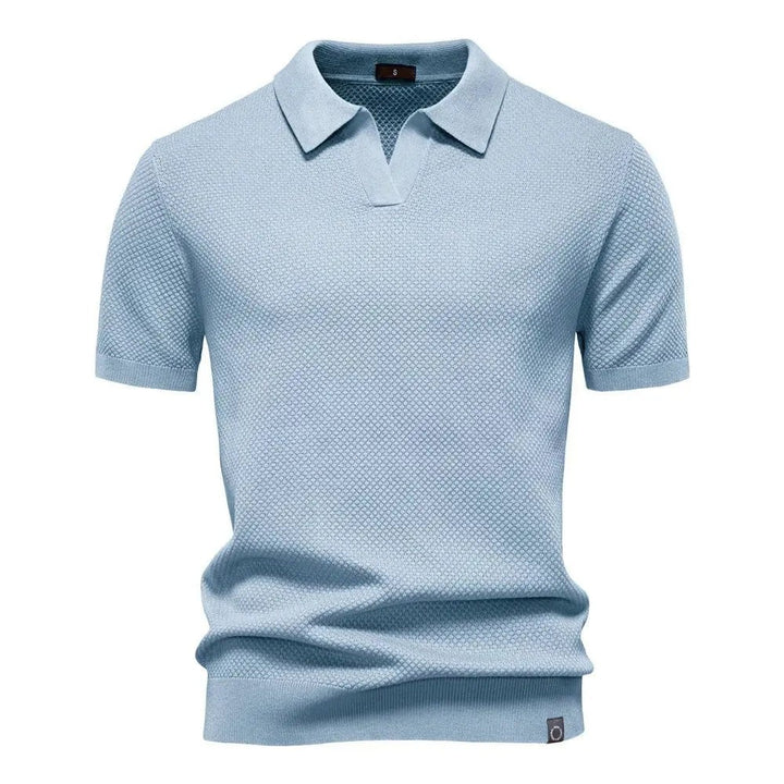 Pale blue knitted polo shirt with short sleeves and collared neckline