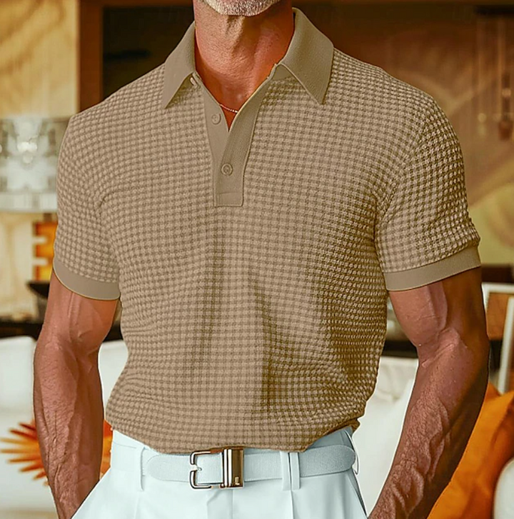 Beige textured waffle polo shirt with buttoned collar, worn with white trousers