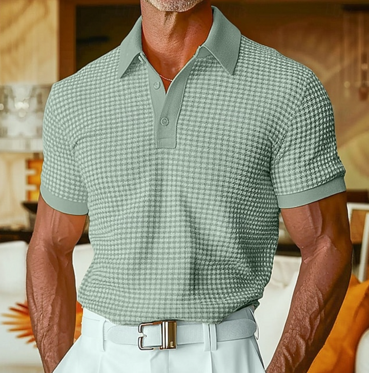 Sage green textured polo shirt with contrast collar, paired with tailored trousers