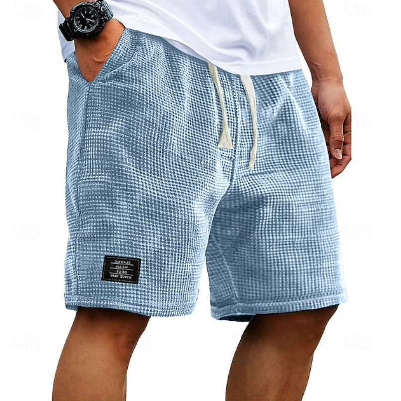 Pale blue waffle-textured shorts with cream drawcord and logo patch