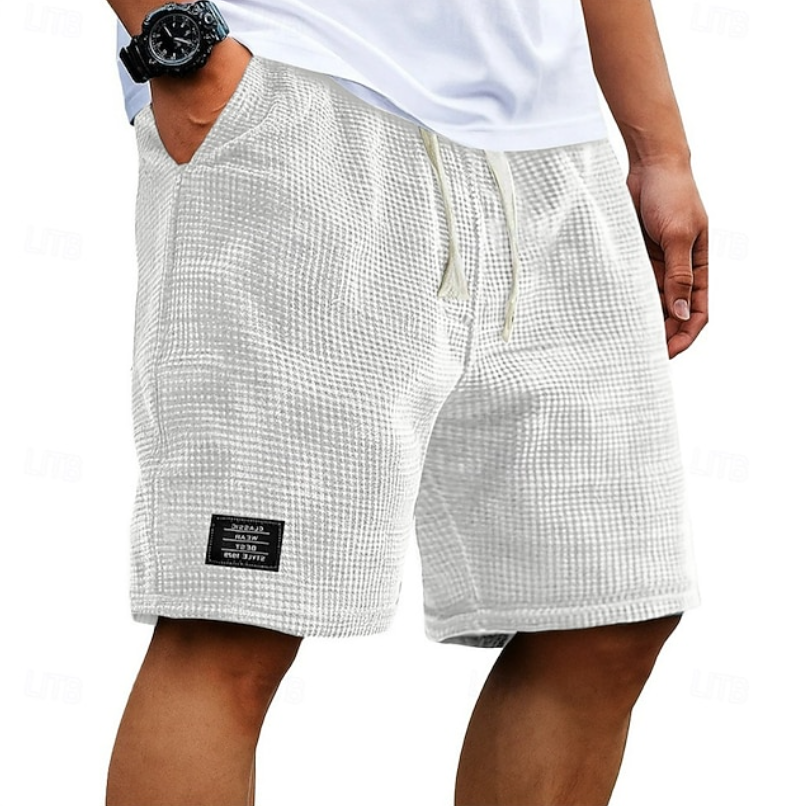 White waffle-textured summer shorts with cream drawcord and branded patch